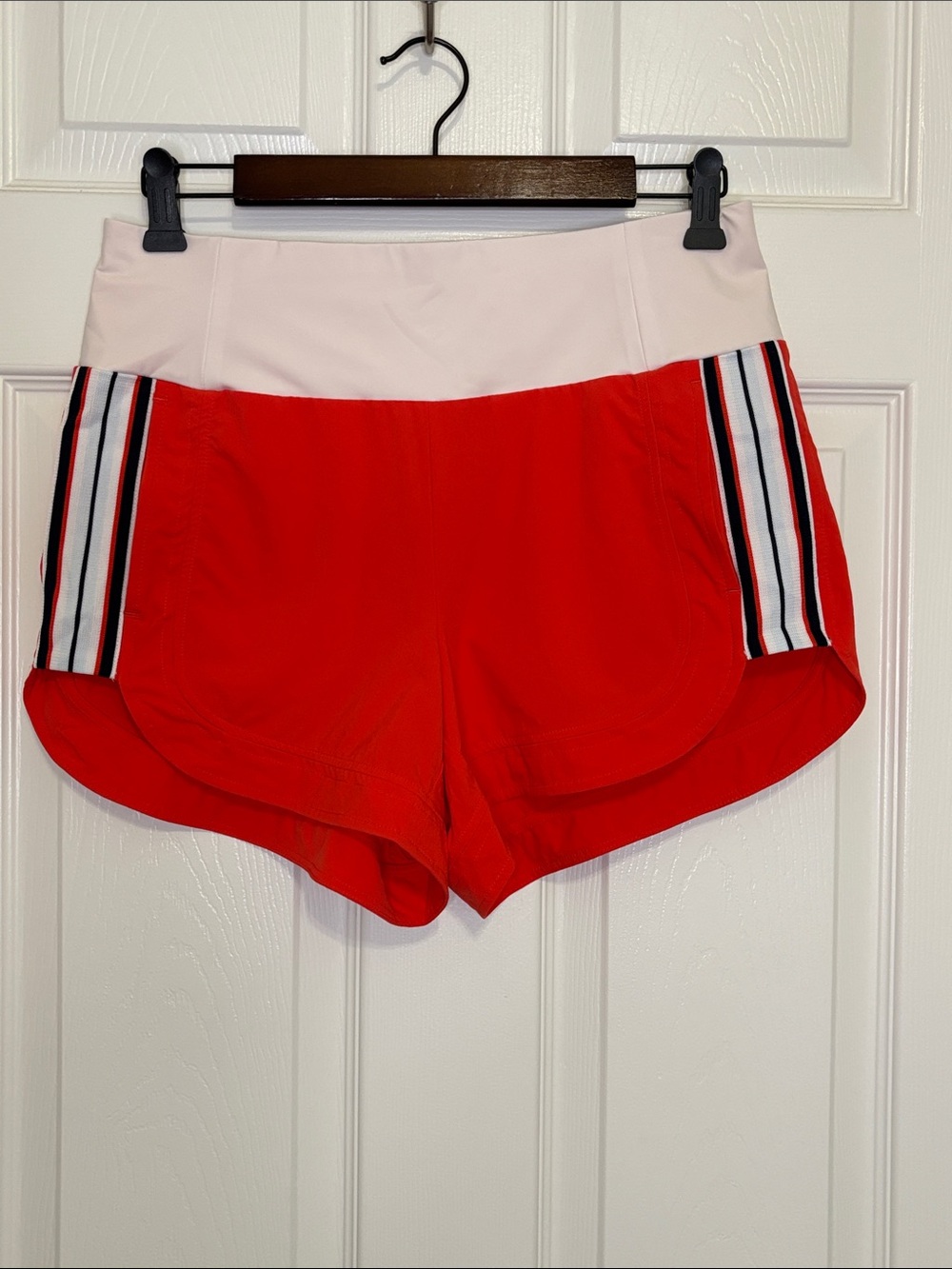 Athleta Bright Orange Athletic Shorts with White Waistband and Side Stripes
